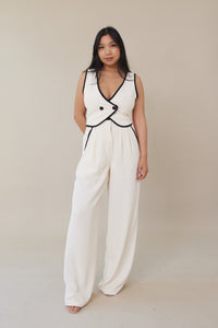 cream high waisted trouser pants relaxed fit black lining accents slight pleating button zipper closure flowy straight leg fit bottoms