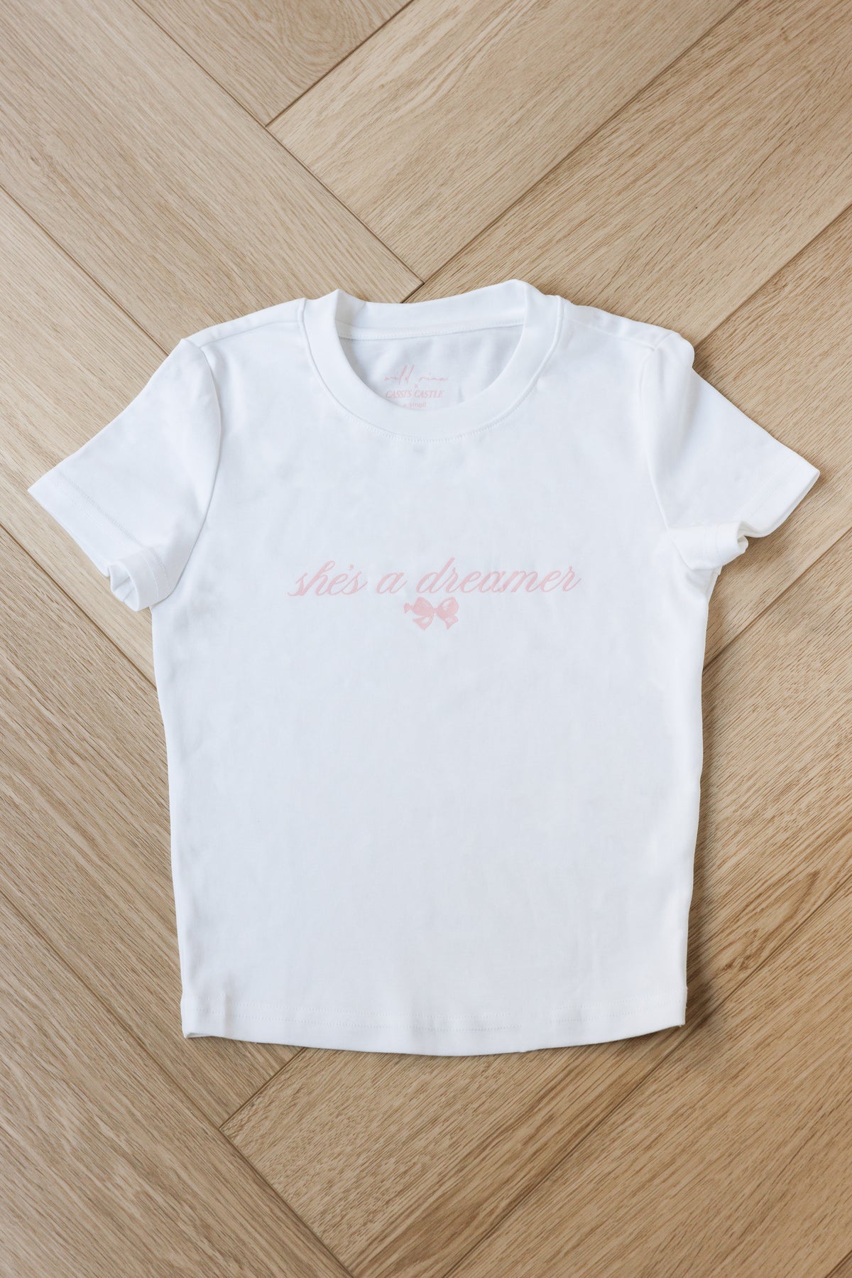 white cotton cropped baby tee round neck with a she's a dreamer design pink bow casual everyday fashion princess disney style