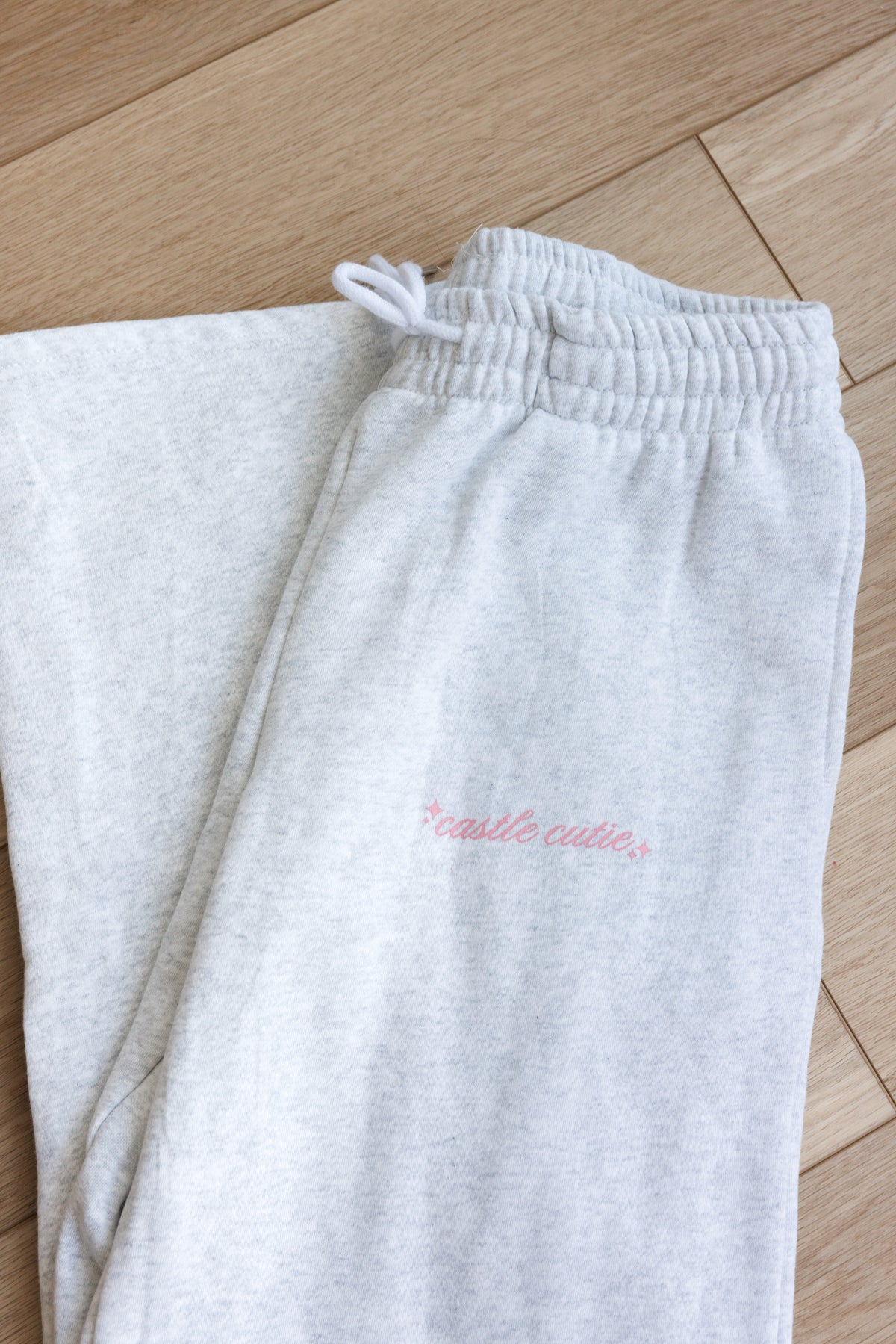 gray fleece lined sweatpants with adjustable drawstring hem straight leg loose oversized fit pink castle cutie design with sparkles perfect for casual cozy wear