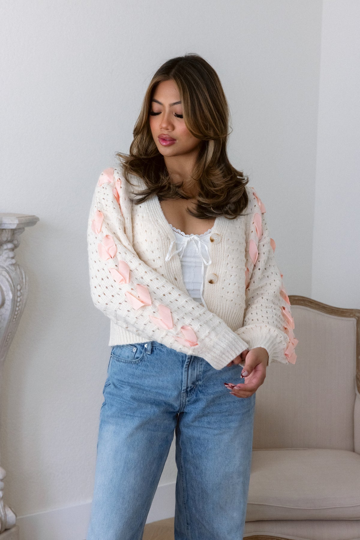 cardigan cropped beige sweater peach crisscross bows v neckline button-down front long sleeves knit fabric