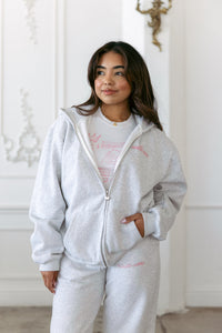 gray fleece zip up jacket with castle cutie design pink bow heart zipper pull oversized fit heavyweight fabric perfect for casual winter loungewear