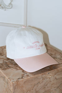 cream colored baseball hat with pink hill embroidered certified castle cutie script pink 1997 embroidered bow on back adjustable ties girly style cap