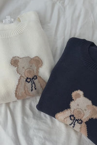 cream knit crewneck sweater long sleeve ribbed cuffs cozy fit cute teddy bear design casual fashion layering street style fall spring winter outfit