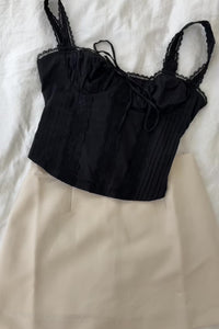 black mlilkmaid style bustier corset ribbow bow front tie lace stretchy tank top cream high waisted mini skort zipper closure snug fitted skirt