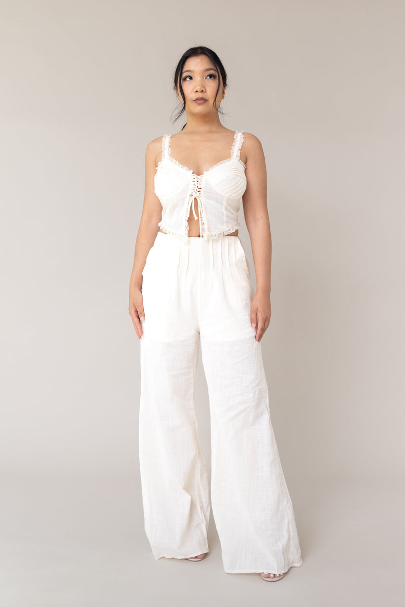 cream two piece outfit coordinated matching set linen corset style adjustable tie front closure sleeveless high waist ruffled lace flare loose pants functional pockets smocked back