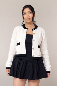 cream knit cardigan round neck chunky gold button front closure pockets long sleeves black cuffs