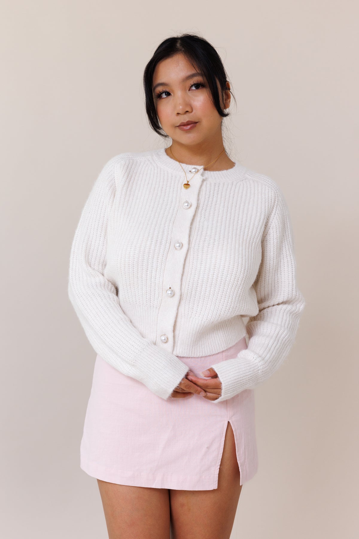 white knit cardigan ribbed cuffed hems  stretchy fit crew neck pearl button front closure long sleeve