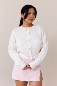 white knit cardigan ribbed cuffed hems  stretchy fit crew neck pearl button front closure long sleeve