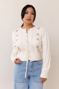 cream knit cardigan sweater long sleeve button front closure adjustable waist front tie floral pink flower ribbed cuffed hems embroidered scallop neckline