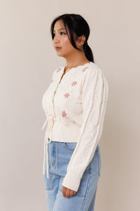 cream knit cardigan sweater long sleeve button front closure adjustable waist front tie floral pink flower ribbed cuffed hems embroidered scallop neckline