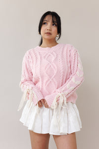 pink cable knit pullover long sleeve sweater round neckline ribbed cuffs lace trim bow romantic fashion cozy wear casual outfit fall winter spring style