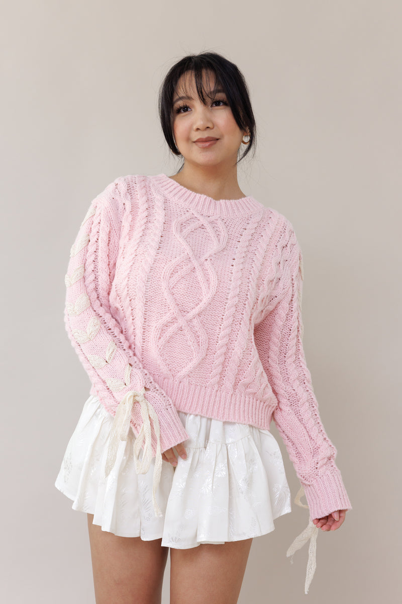 pink cable knit pullover long sleeve sweater round neckline ribbed cuffs lace trim bow romantic fashion cozy wear casual outfit fall winter spring style