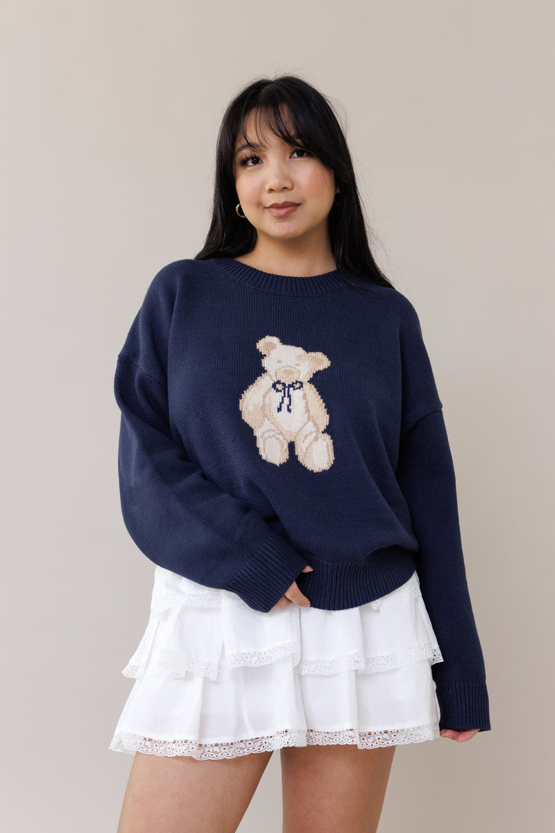 blue knit crewneck sweater long sleeve ribbed cuffs cozy fit cute teddy bear design casual fashion layering street style fall spring winter outfit