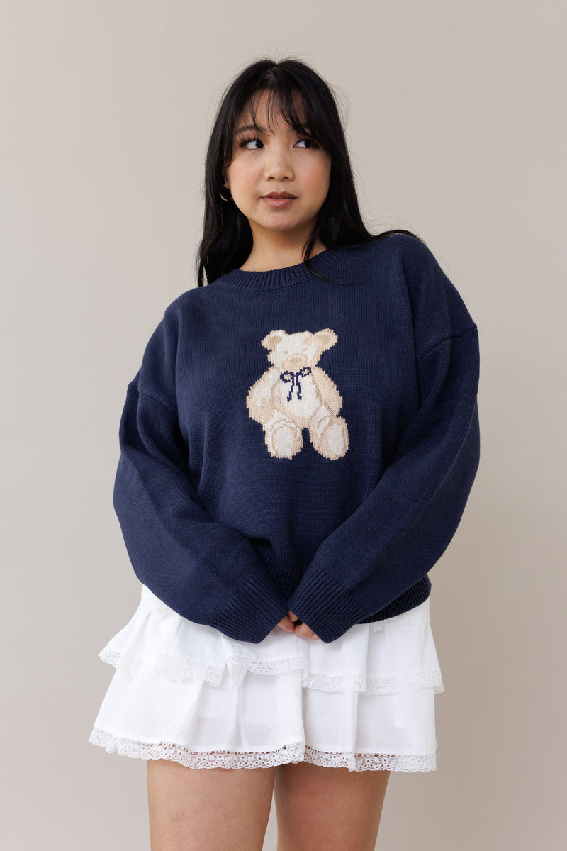 blue knit crewneck sweater long sleeve ribbed cuffs cozy fit cute teddy bear design casual fashion layering street style fall spring winter outfit