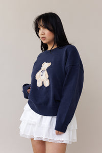 blue knit crewneck sweater long sleeve ribbed cuffs cozy fit cute teddy bear design casual fashion layering street style fall spring winter outfit