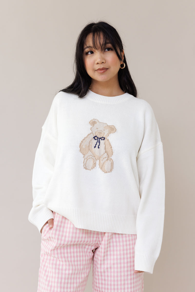 cream knit crewneck sweater long sleeve ribbed cuffs cozy fit cute teddy bear design casual fashion layering street style fall spring winter outfit