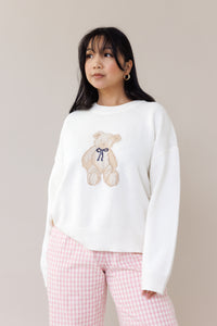 cream knit crewneck sweater long sleeve ribbed cuffs cozy fit cute teddy bear design casual fashion layering street style fall spring winter outfit