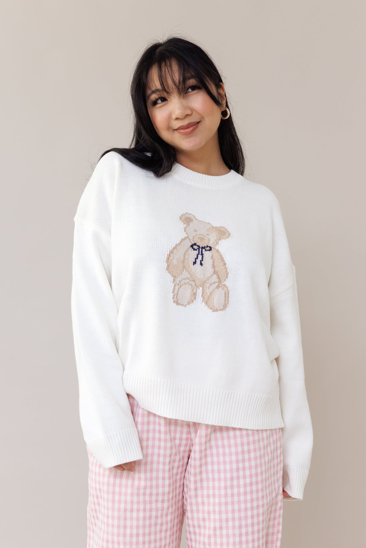 cream knit crewneck sweater long sleeve ribbed cuffs cozy fit cute teddy bear design casual fashion layering street style fall spring winter outfit