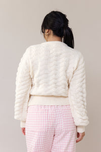 cream knit cardigan textured fabric relaxed fit button down rosette accents pink flower button long puff sleeves ribbed cuffs romantic outfit fall winter spring fashion